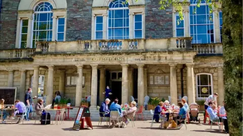 People enjoying the sunshine in Carmarthen