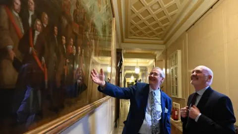 PA Media Dr Éamon Phoenix with Alex Maskey at Stormont in March 2022