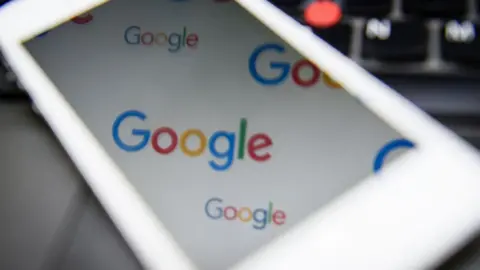 AFP Google logo reflected in a phone screen