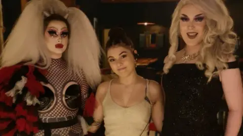 Liv Lewis Liv Lewis (centre) with her friends and colleagues Zodi (L) and Dahliah (R)