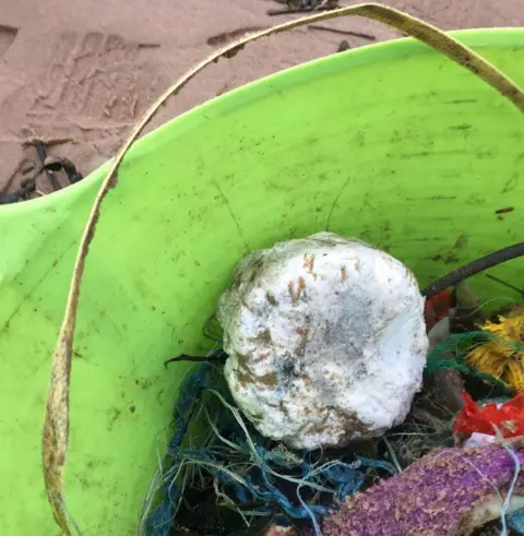 Annabelle Jennings Washed up palm oil in bucket