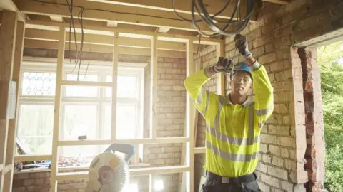 Getty Images Man building house