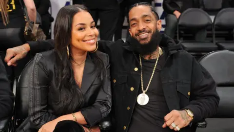 Getty Images Nipsey Hussle and Lauren London at an NBA game