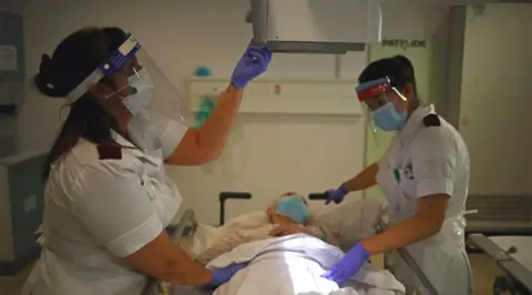 Getty Images Staff care for patient