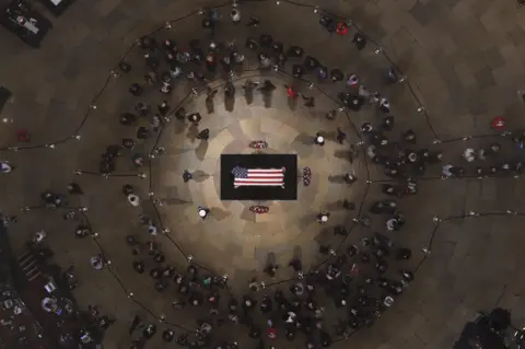 Getty Images Members of the public pay their respects in the Capitol Rotunda