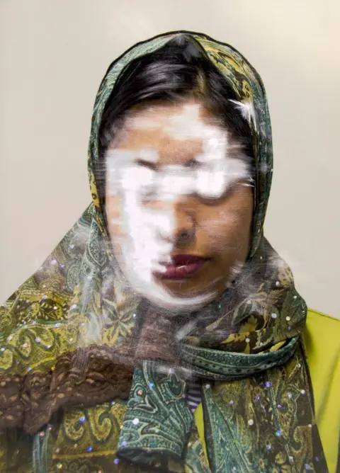 Sam Ivin A portrait of a woman with her face obscured by scratches to the photograph