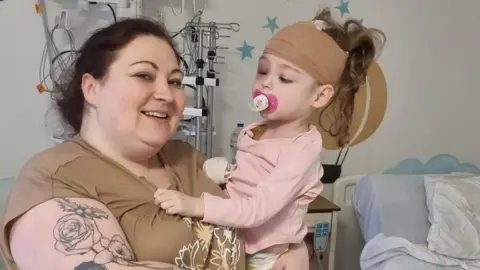 Katie Jennings Katie Jennings holding her daughter Rachel in hospital