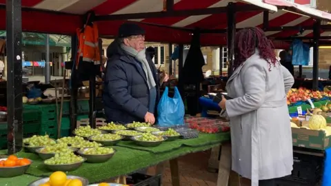 Sara Palmer/BBC Market trader