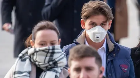 PA Media People wearing masks