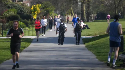 Getty Images Police officers were seen walking through Greenwich Park in London