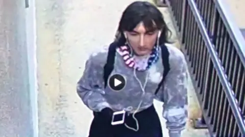 Police handout The suspect disguised himself as a woman to escape with fleeing onlooker