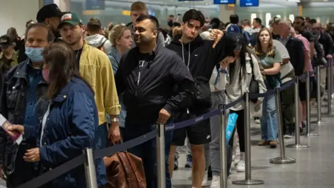 Getty Images Long queues at Heathrow security in 2022.