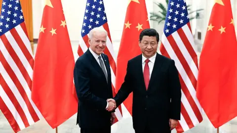 Getty Images : Chinese President Xi Jinping (R) shake hands with U.S Vice President Joe Biden (L) inside the Great Hall of the People on December 4, 2013 in Beijing, China