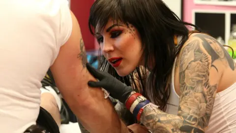 Getty Images Kat Von D pictured tattooing during World Record attempt in 2007