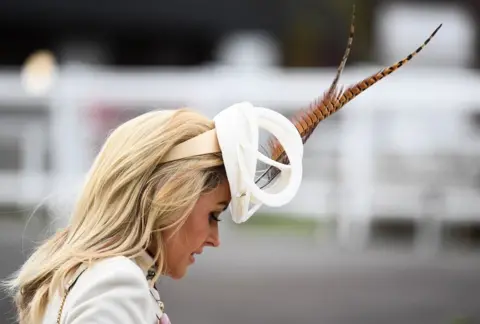 BPI/Shutterstock A racegoer during Ladies Day of the 2019 Cheltenham Festival at Cheltenham Racecourse