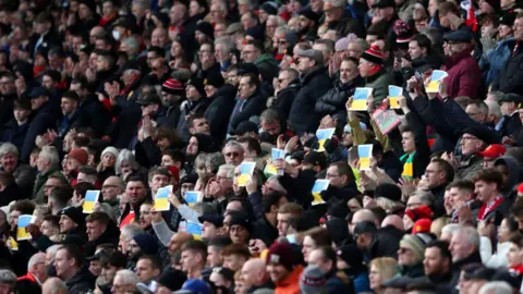 Getty Images Fans hold up Ukrainian flags at Old Trafford