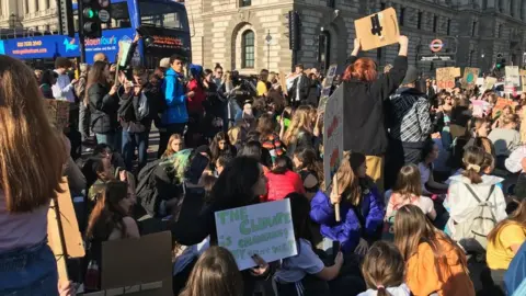 Protestors sitting down in the road