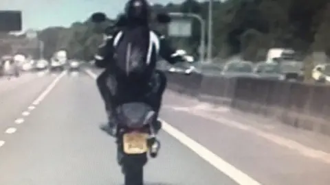 CMPG Biker performing wheelies on M6