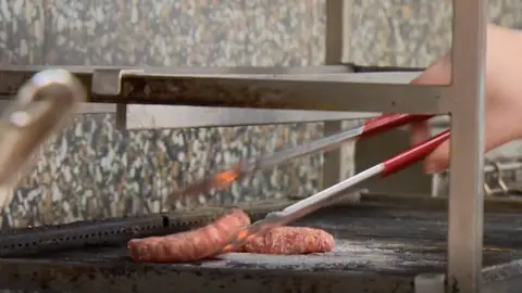 Chef flipping burgers