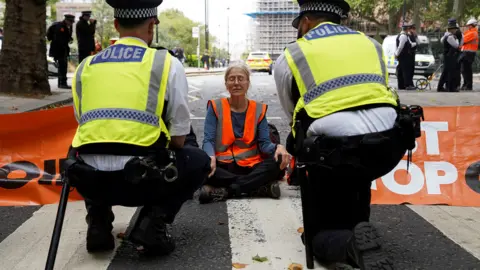 Reuters A Just Stop Oil protester blocking the road