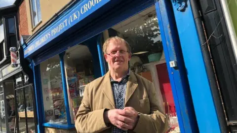 Gerald Hirst in front of the shop