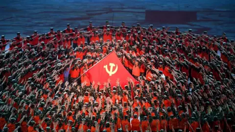 Getty Images Performers dance during a Cultural Performance as part of the celebration of the 100th Anniversary of the Founding of the Communist Party of China, at the Bird's nest national stadium in Beijing on June 28, 2021