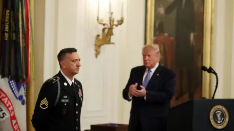 Getty Images Trump applauds for Medal of Honor winner