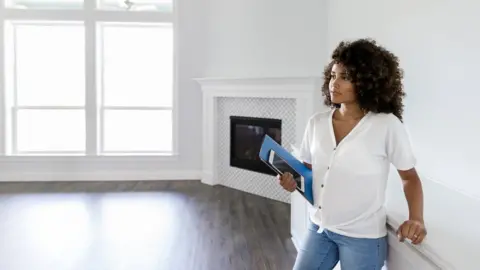 Getty Images Woman in unfurnished apartment