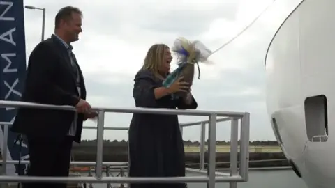 IOMSPC Janice McDowall breaking the bottle against the ship's bow