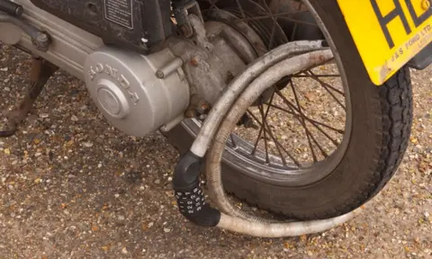 Alamy Moped with wheel lock