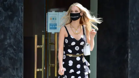 Getty Images Joy Corrigan wearing a mask while shopping in Los Angeles in April of this year