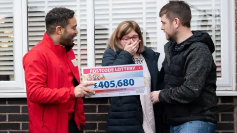 People's Postcode Lottery/PA Media Rachel Lee, 33, an NHS support worker Dukinfield, Greater Manchester, with her husband John, 37 (right)