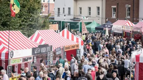 Artur Tixiliski/Abergavenny Food Festival Festival goers fill a road of market stalls at Abergavenny Food Festival 2017