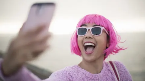 Getty Images A woman taking a selfie