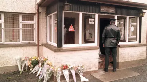 Pacemaker A police officer at the Heights Bar in Loughinisland after the attack in 1994