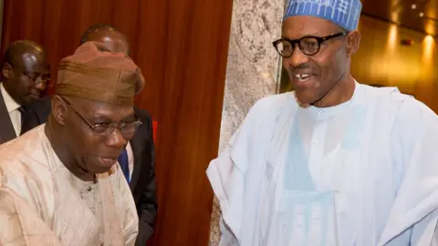 Getty Images Ex-President Olusegun Obasanjo and President Muhammadu Buhair shaking hands in 2015