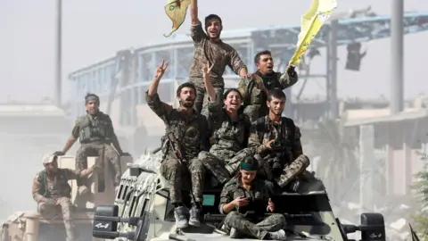 Reuters Syrian Democratic Forces fighters celebrate victory in Raqqa, Syria (17 October 2017)