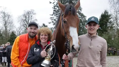 Corach Rambler with trainer Lucinda Russell and owners Cameron Sword (right) and Thomas Kendall