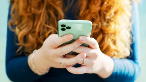 Getty Images Woman using mobile phone