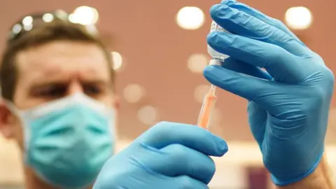 Getty Images Picture of a man holding a vaccination