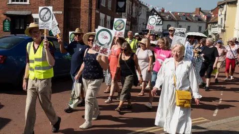 Future Newent Protestors walking down a street