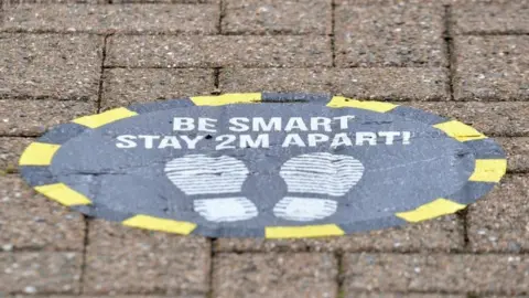 PA Media Sign asking people to stay 2m apart