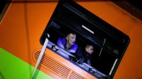 Reuters Rescuers work inside one of the damaged carriages in Mexico City, Mexico. Photo: 4 May 2021