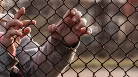 Andrei310 Child behind wire