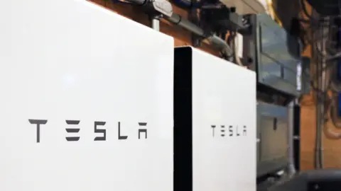 Getty Images Tesla powerwalls are pictured here in this photo of an apparent garage area