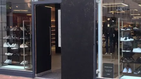 shop with doors boarded up