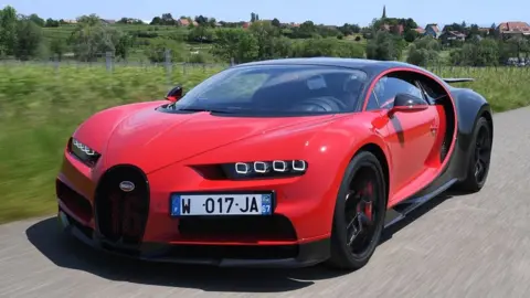 AFP A driver steers a Bugatti Chiron near the luxury automobiles manufacturer Bugatti's headquarters in Molsheim, eastern France (2019 file picture)
