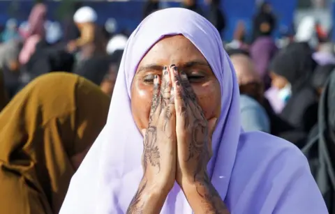 Monicah Mwangi / Reuters A Muslim woman attends Eid al-Fitr prayers