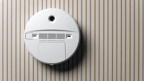 Getty Images Carbon monoxide alarm mounted on a wall