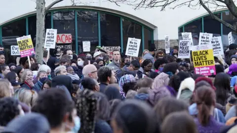 PA Media People outside Stoke Newington Police Station in London, over the treatment of a black 15-year-old schoolgirl who was strip-searched by police while on her period. The secondary school pupil - referred to as Child Q - has launched civil proceedings against the Metropolitan Police over the search by two female officers, without another adult present, in 2020.